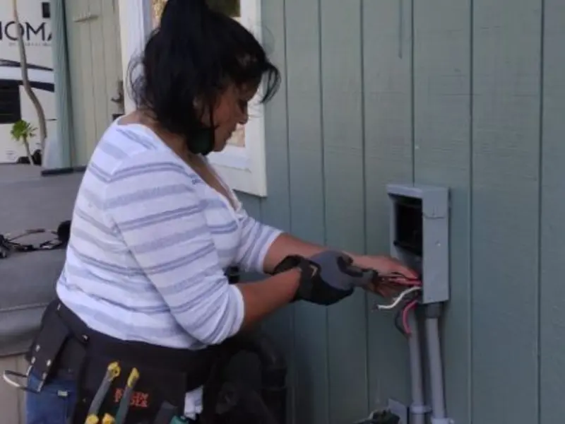Licensed electrician wiring an exterior subpanel in Mitchellville